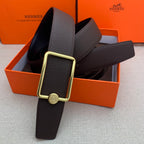 Leather belt with rectangular gold buckle and embossed strap, dark brown.