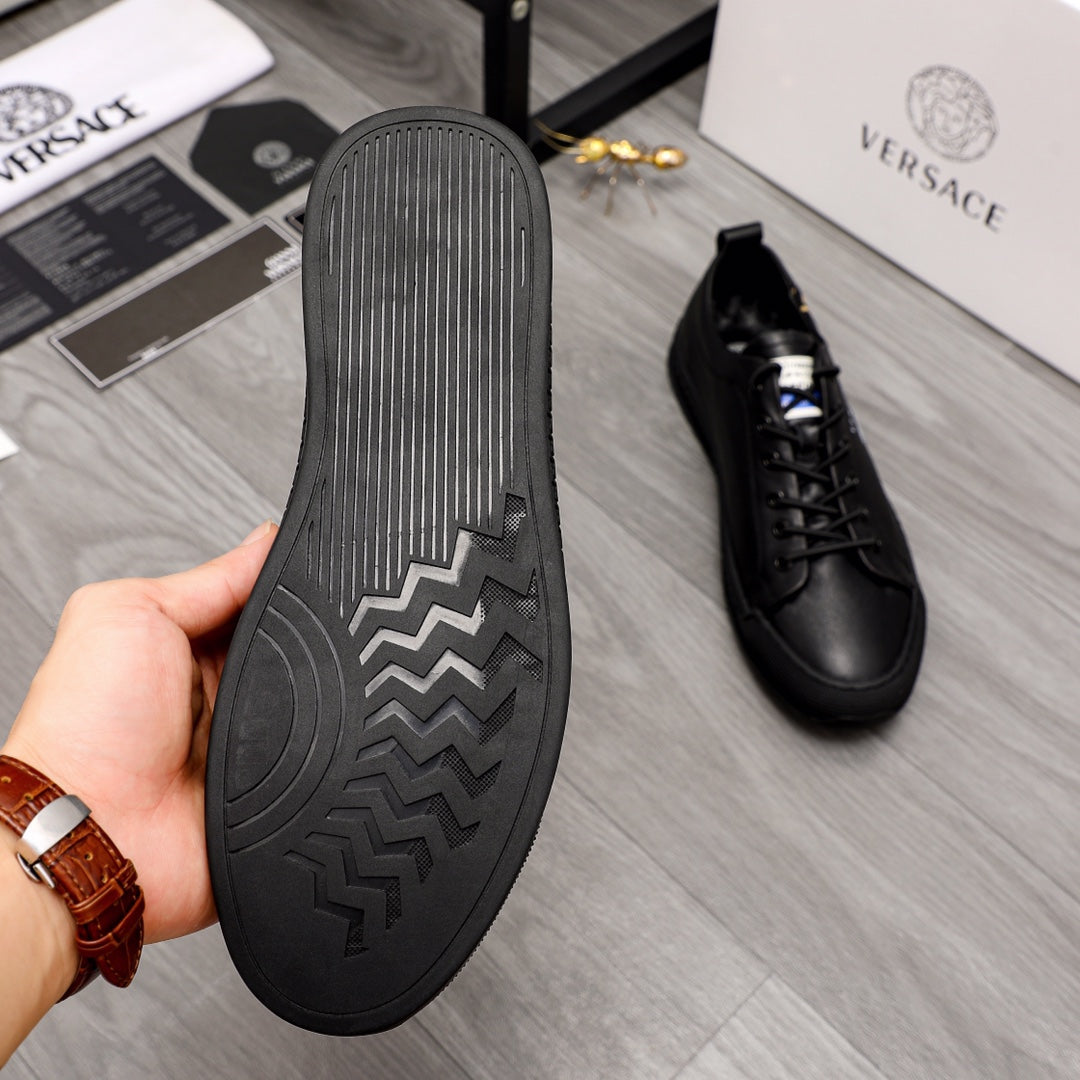 Versace black sneaker soles with tread pattern and zigzag logo detail