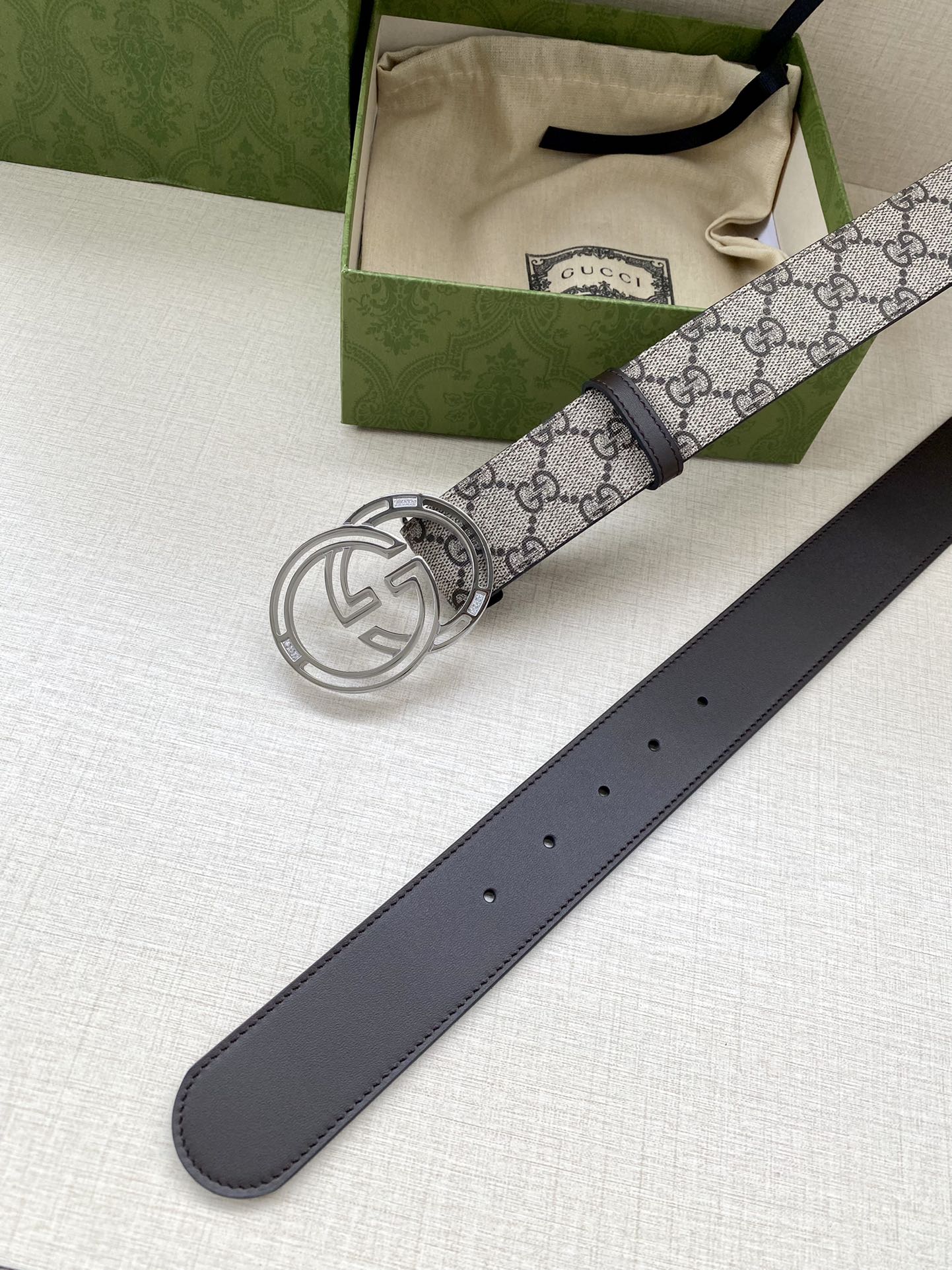 Gucci belt full view: GG canvas belt with silver-tone buckle and dark leather strap