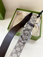 Gucci belt with GG canvas strap, dark leather strap, and silver-tone double G buckle