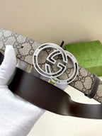 Gucci belt close-up: GG canvas strap with silver-tone buckle and dark leather backing