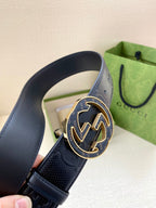 Gucci dark navy belt close-up of GG-logo buckle with gold-tone trim