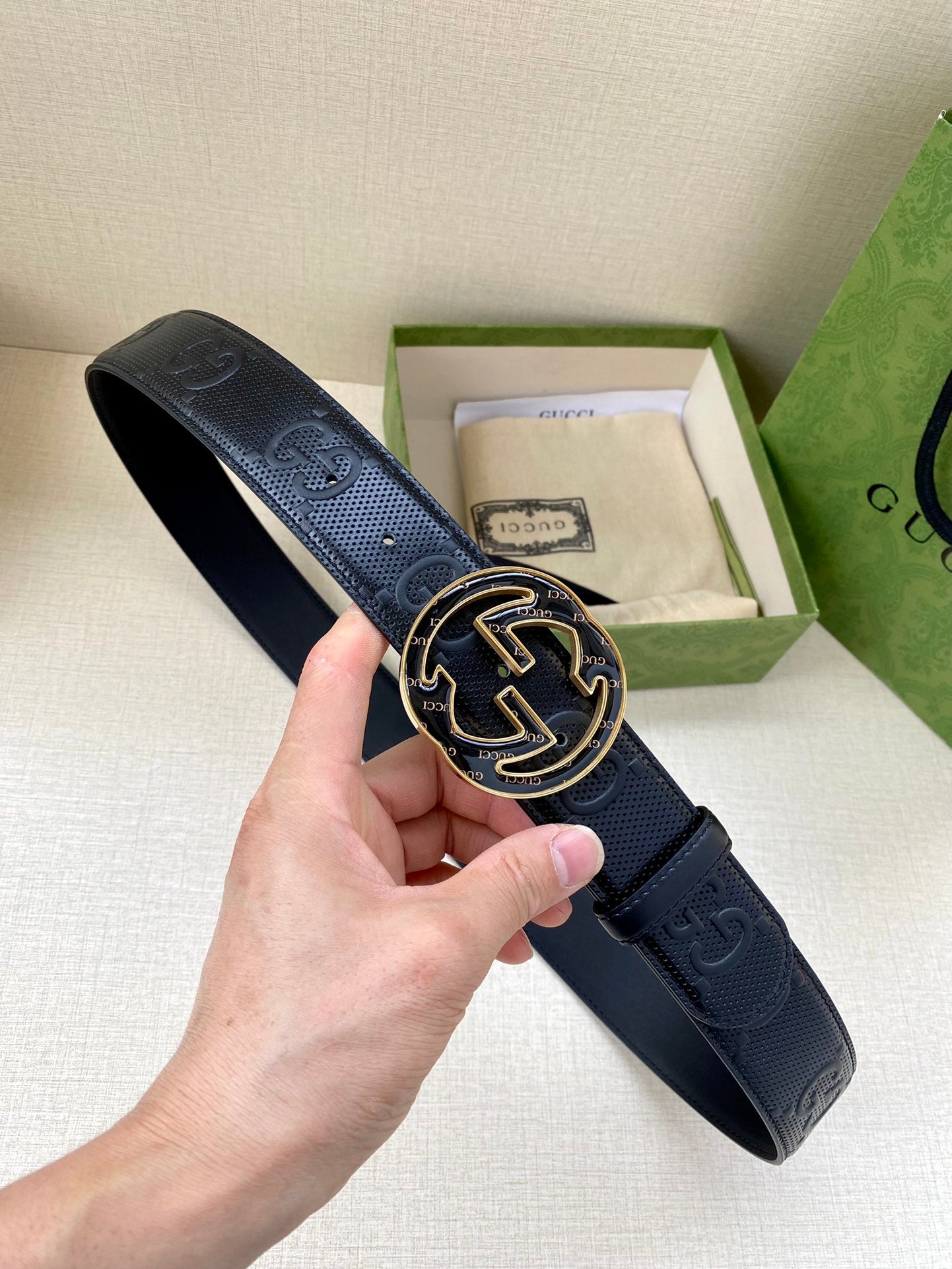 Gucci dark navy leather belt with GG-pattern buckle in silver and gold-tone