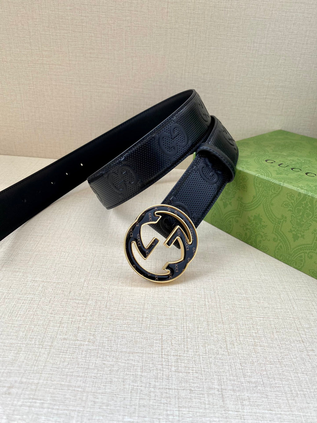 Gucci dark navy leather belt with oval GG buckle and textured belt strap