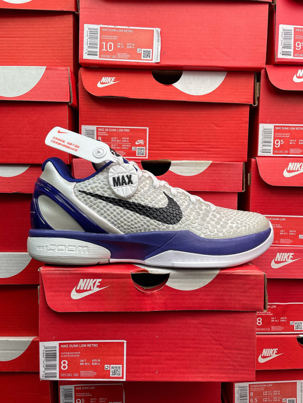 White and blue basketball sneaker with black swoosh and 'MAX' heel detail.