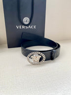 Black Versace belt with embossed texture and silver-tone Medusa oval buckle