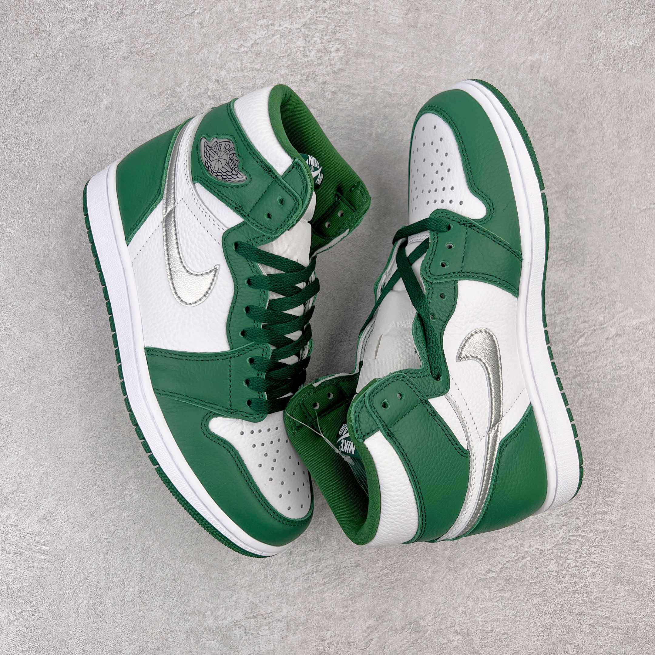 Pair of green and white high-top sneakers with laces and side Swoosh