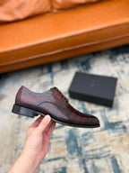 Dior unisex lace-up dress shoe in burgundy crocodile-embossed leather, held close