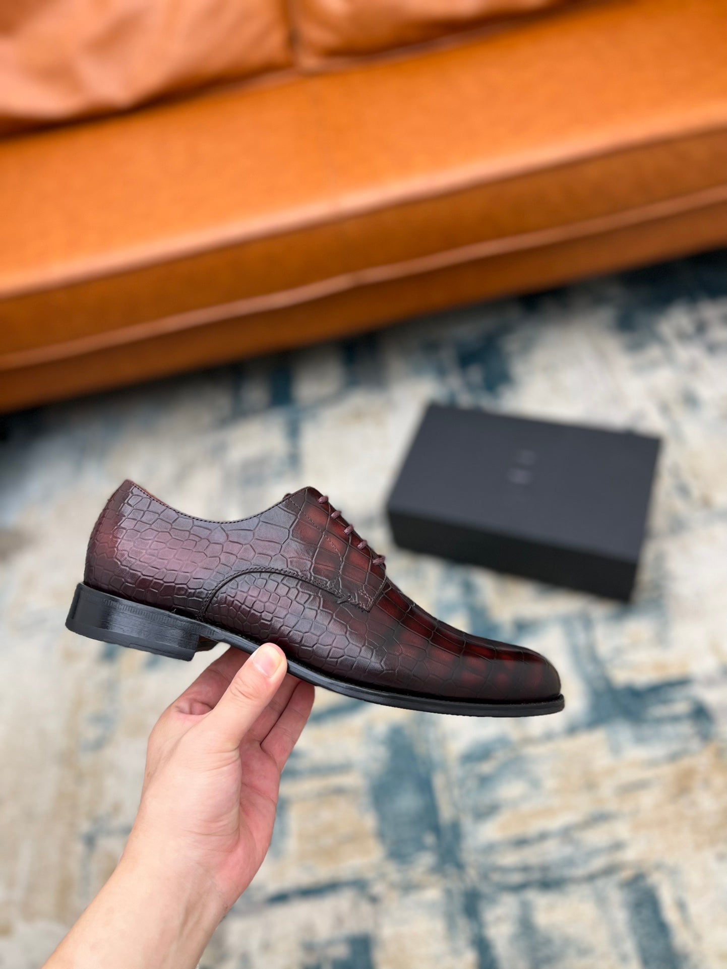 Dior unisex lace-up dress shoe in burgundy crocodile-embossed leather, held close