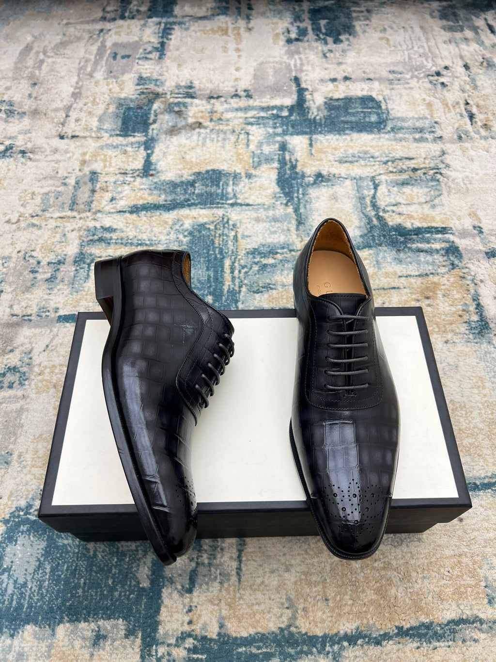 Black leather lace-up dress shoes, side view with stitched detailing