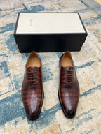 Gucci unisex leather lace-up dress shoes, dark brown textured upper, front pair