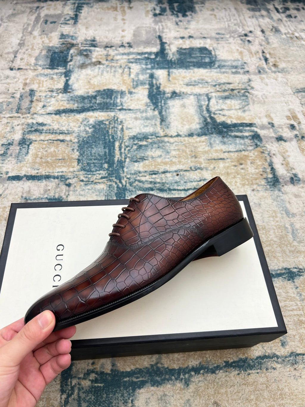 Gucci unisex leather lace-up dress shoe, dark brown textured upper, laces close-up