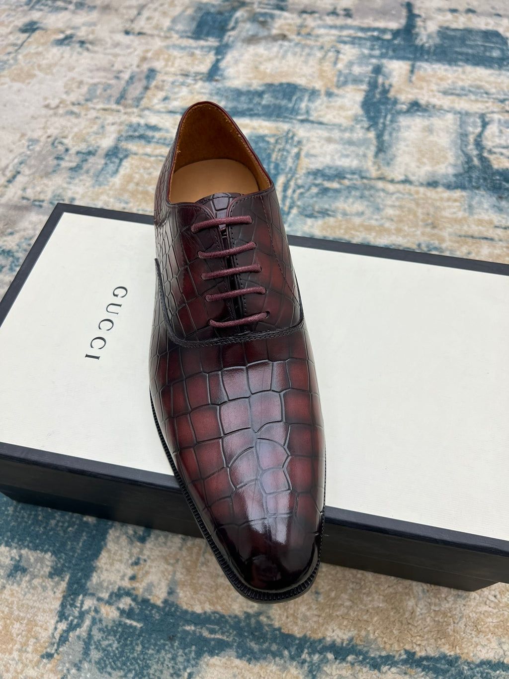 Lace-up dress shoe, burgundy croc-textured leather, front view with laces.
