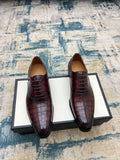Gucci unisex lace-up dress shoes, burgundy croc-textured leather, black sole.