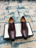 Gucci unisex lace-up dress shoes, burgundy croc-textured leather, black sole.