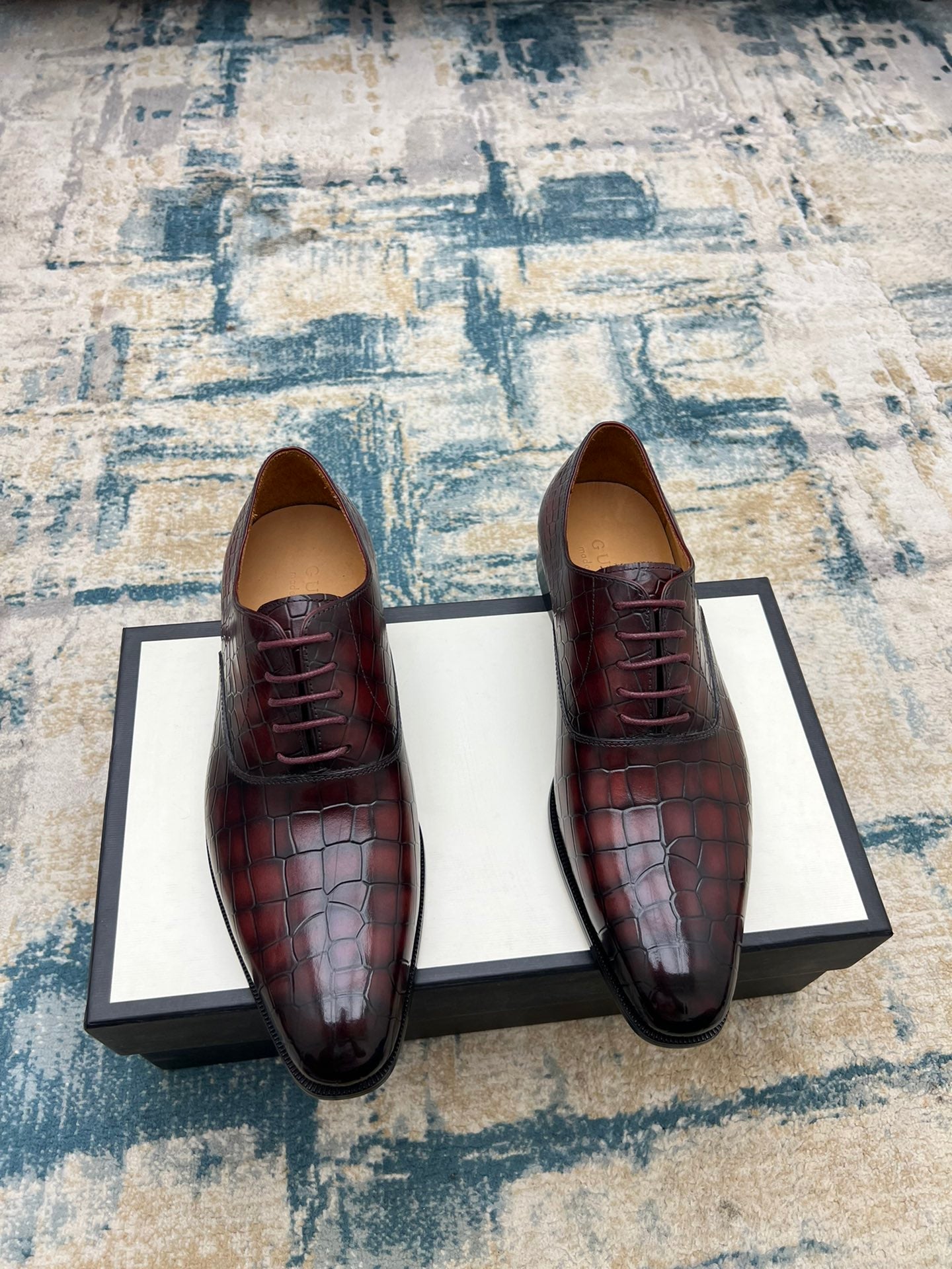 Gucci unisex lace-up dress shoes, burgundy croc-textured leather, black sole.
