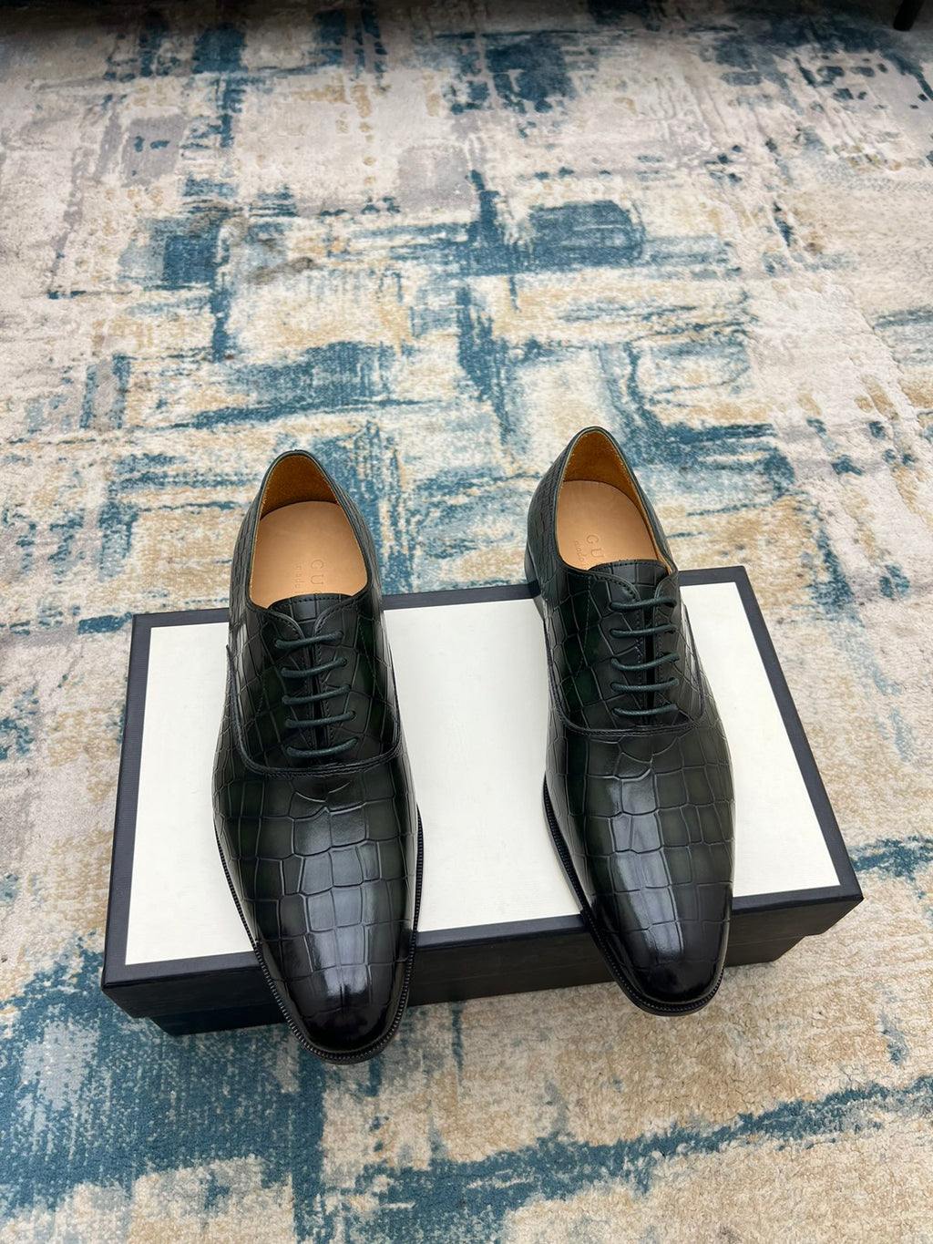 Black crocodile-embossed lace-up dress shoes, two shoes on box