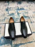 Black crocodile-embossed lace-up dress shoes, two shoes on box