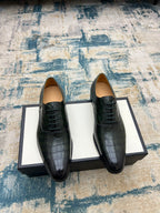 Black crocodile-embossed lace-up dress shoes, two shoes on box