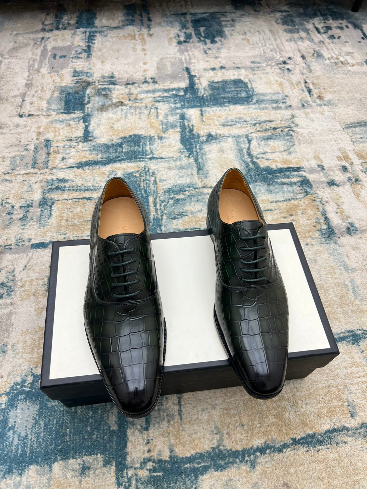 Black crocodile-embossed lace-up dress shoes, two shoes on box