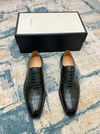Black crocodile-embossed lace-up dress shoes with tan insoles, front view