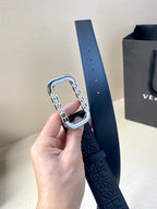 Navy leather belt with embossed design and silver-tone square buckle.