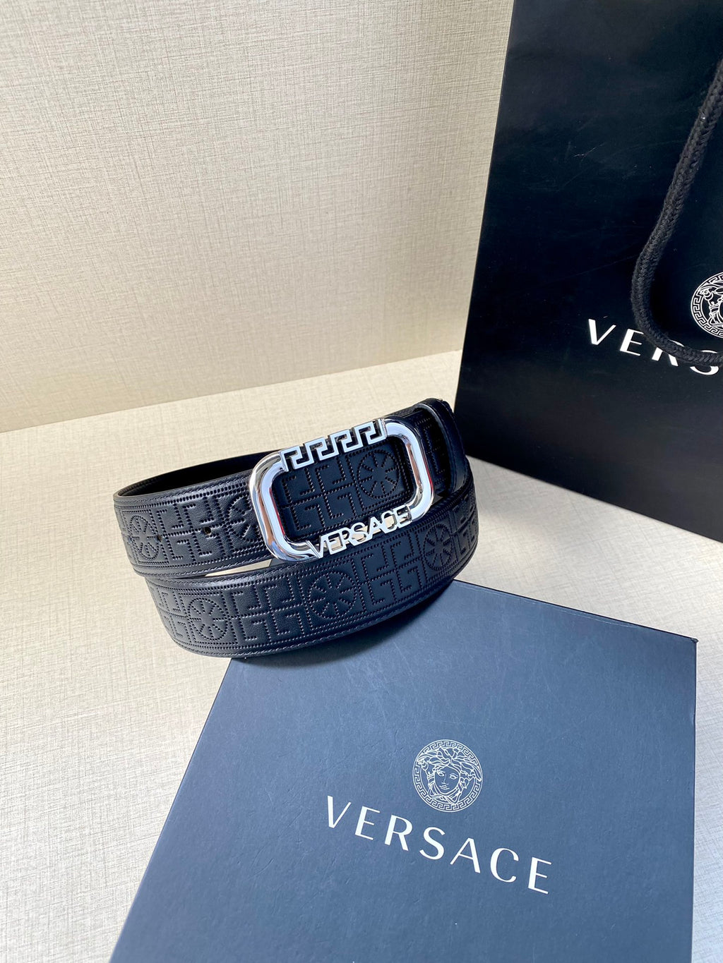 Navy embossed leather belt with silver-tone buckle.