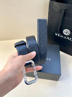 Versace belt strap with dark blue monogram pattern and silver-toned buckle close-up