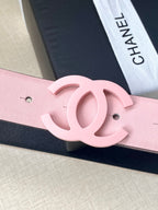 Pink leather belt with oversized CC buckle detail and punch holes