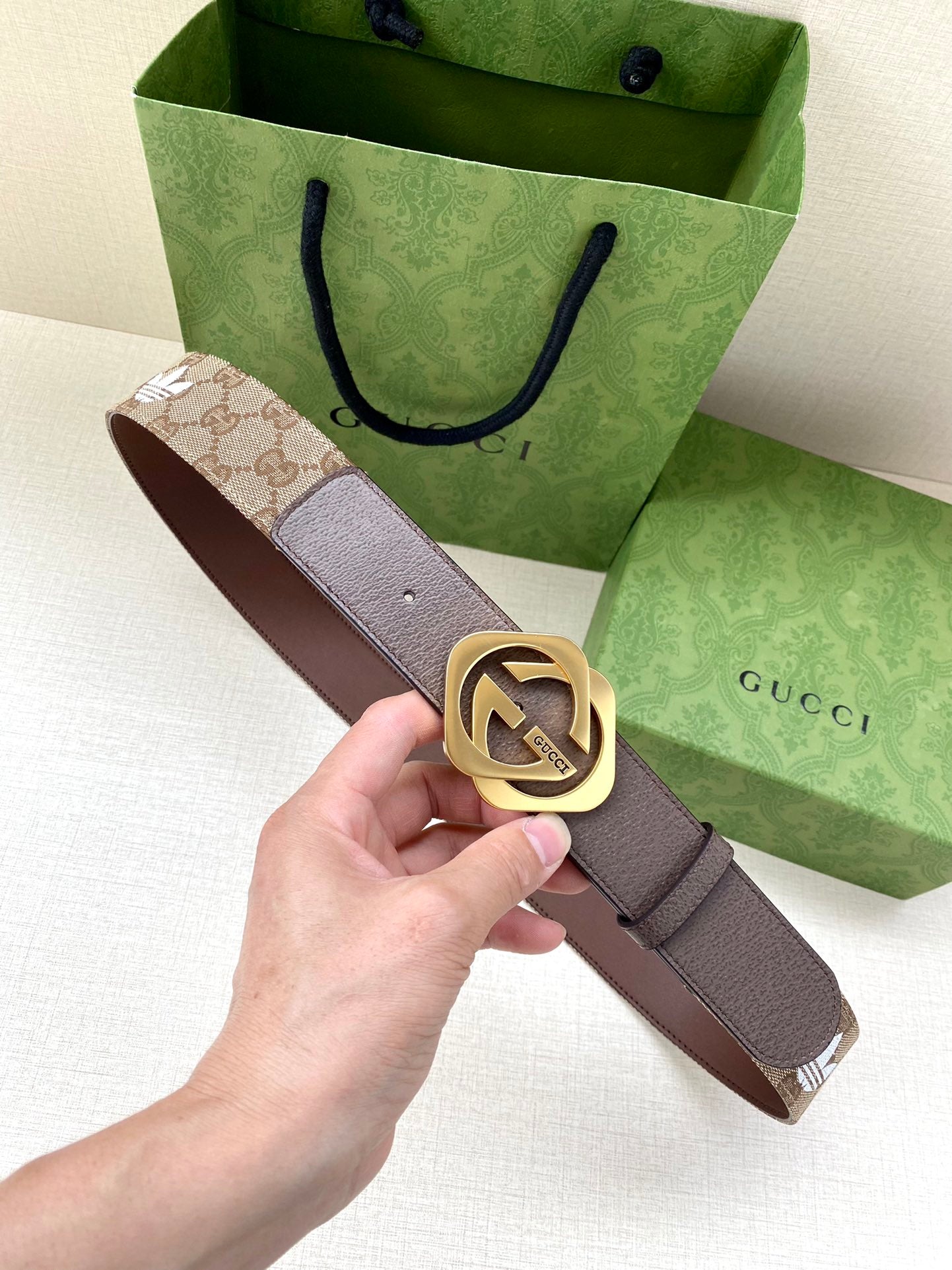 Gucci belt with dark brown leather strap and gold-tone interlocking double G buckle