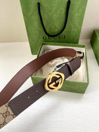 Gucci belt with brown leather strap, beige monogram panel, and gold-tone buckle