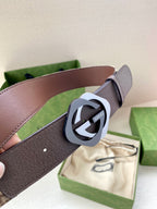 Gucci belt close-up with dark brown strap and GG-ring buckle
