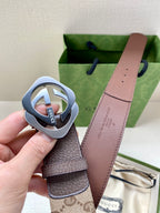 Gucci belt buckle close-up with dark strap and brown leather back
