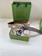 Gucci monogram belt with dark strap and GG buckle