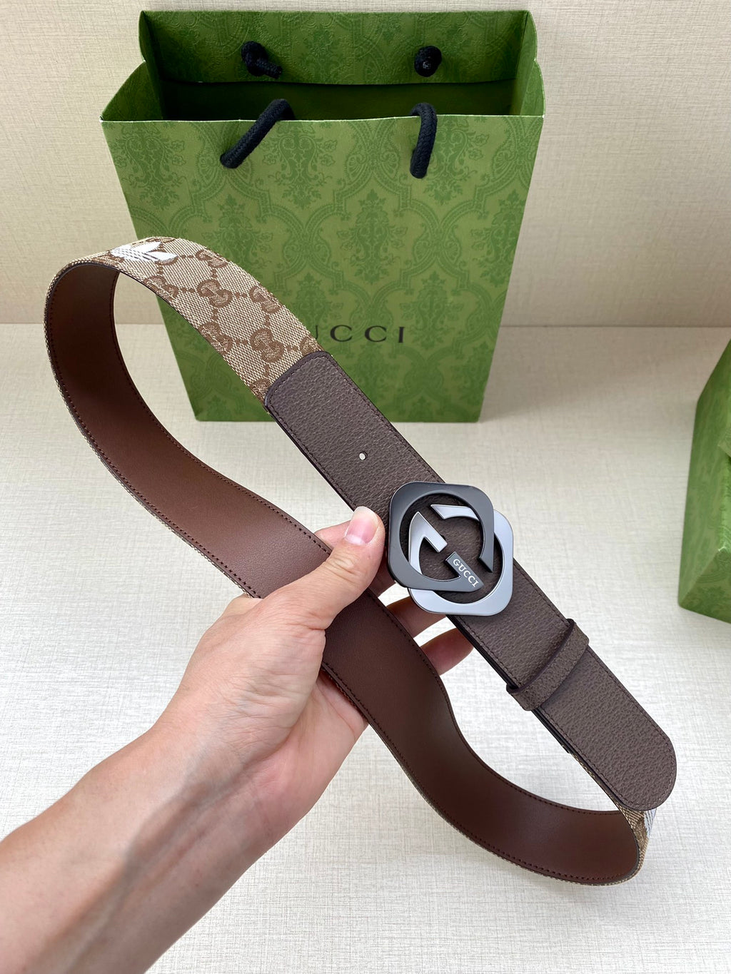 Gucci belt with monogram strap and dark buckle detail