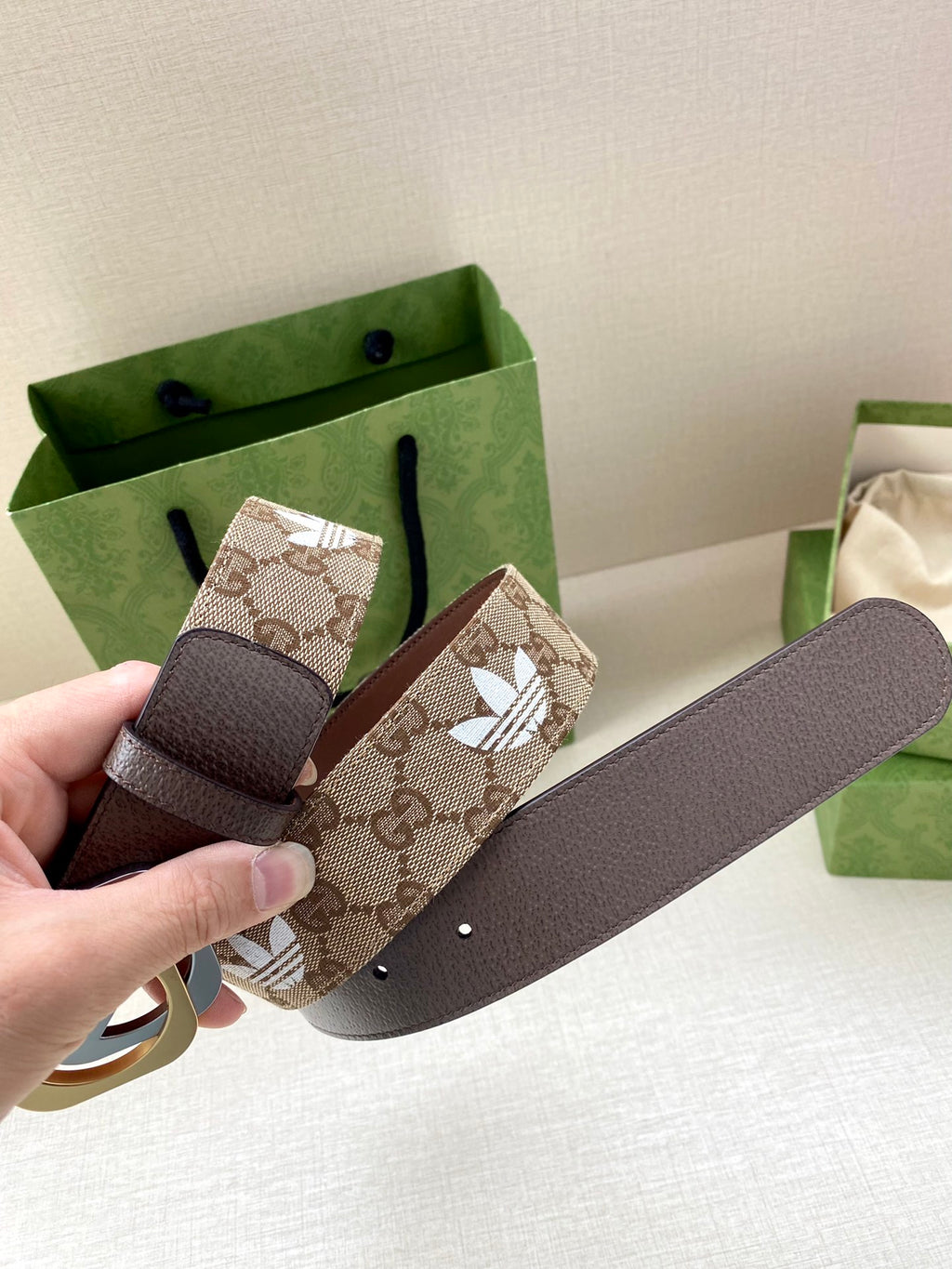 Gucci belt with dark-brown leather strap, monogram tab, circular logo buckle