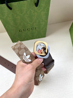 Gucci belt with dark strap and patterned beige end tab, circular logo buckle