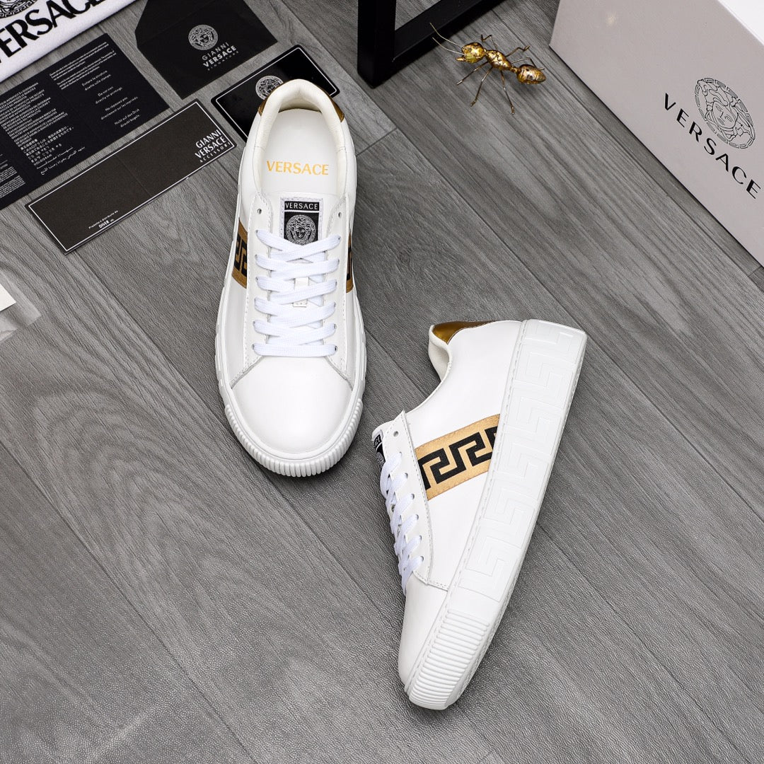 Pair of white low-top leather sneakers with gold logo stripe and gold heel lining