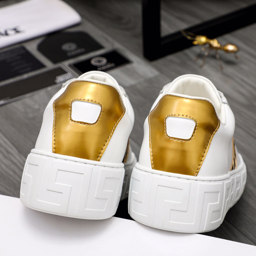 Rear view of white leather sneakers with gold heel panels and grippy outsole