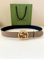 Gucci belt with taupe leather strap and gold-toned round G buckle