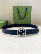 Navy leather belt with round silver logo buckle
