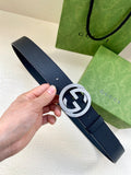 Navy leather belt with round silver GG buckle and textured strap holes