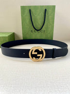 Navy leather belt with round gold GG buckle and textured strap
