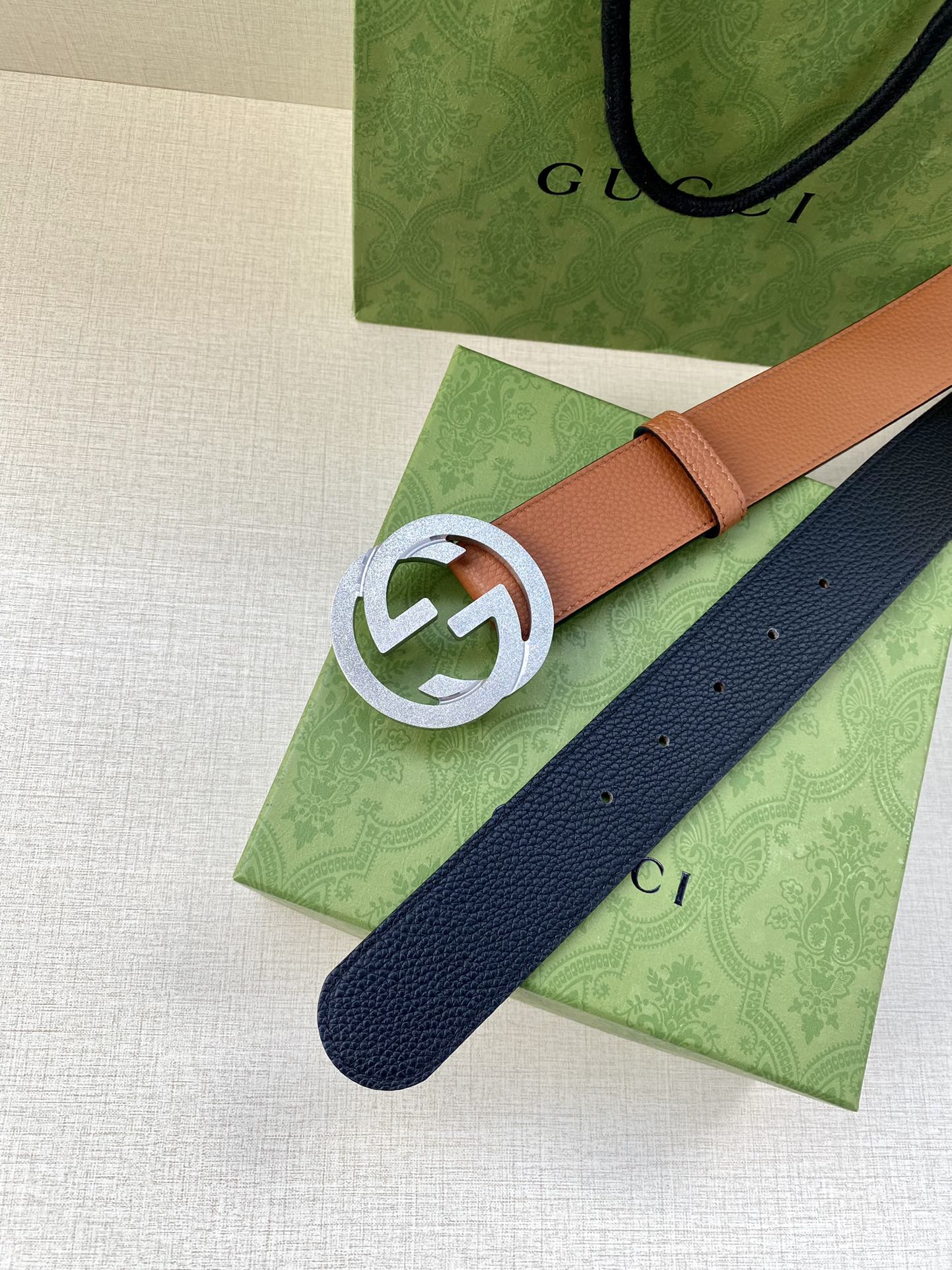 Gucci belt with tan strap and navy reverse, silver GG buckle and end holes