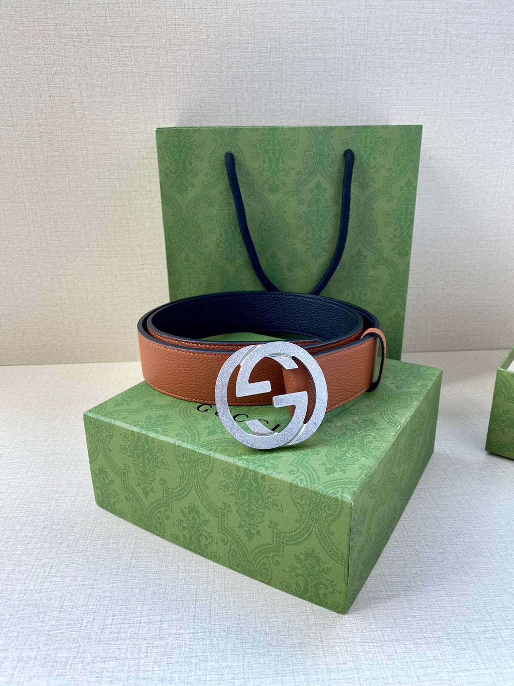 Gucci belt with tan leather strap and silver GG buckle, on box