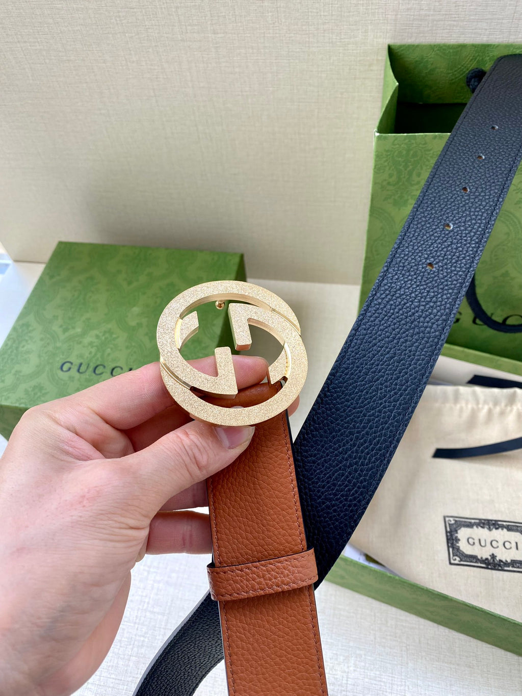 Gucci belt with tan leather strap and round silver GG buckle detail