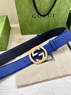 Gucci belt with blue and dark navy strap, featuring a gold-toned GG buckle