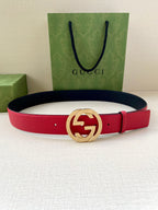 Red leather belt with gold-tone interlocking G buckle on navy-backed strap