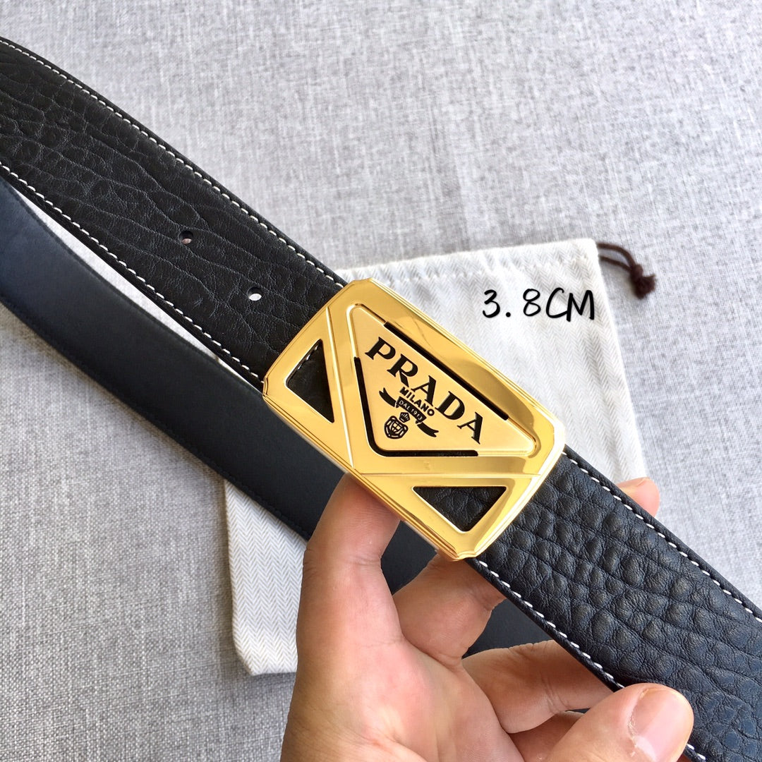 Prada belt buckle close-up on black textured strap with gold PRADA hardware