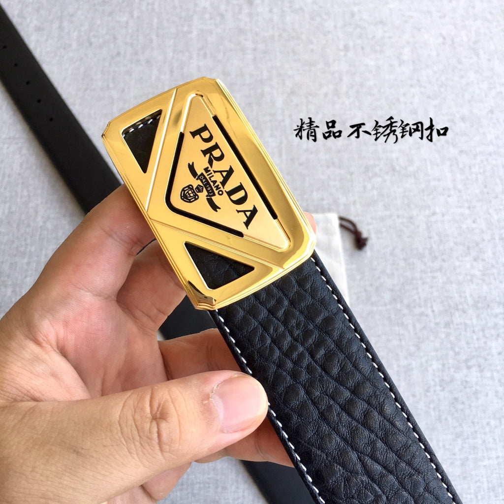 Prada buckle close-up on black textured belt strap with gold PRADA emblem